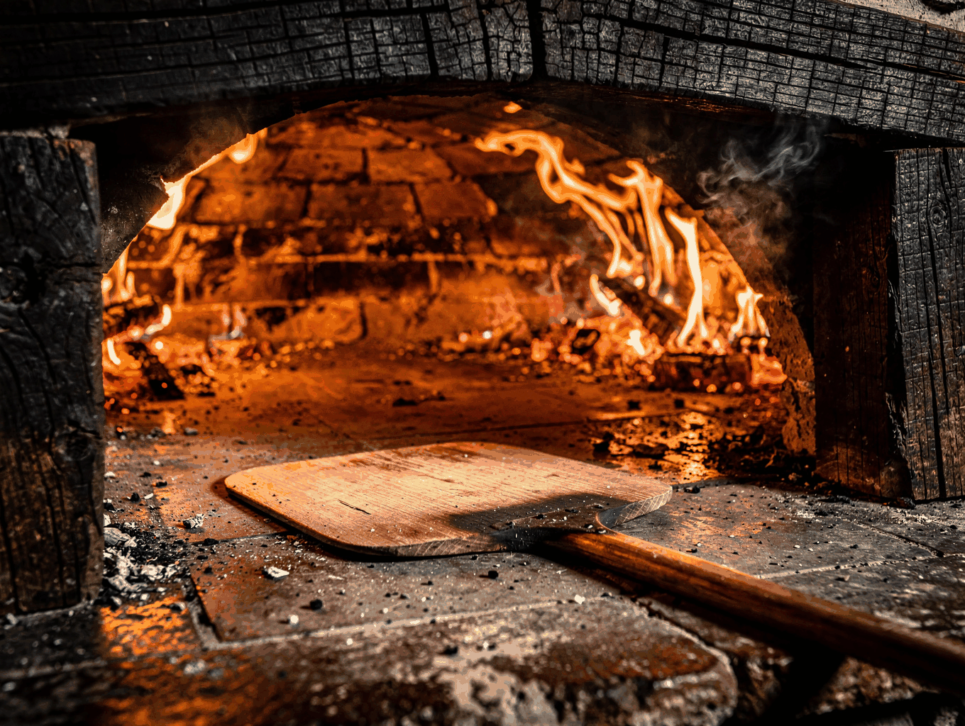 Traditional stone oven glowing with oak fire